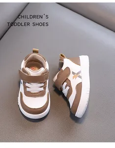 Detailed view of brown and white toddler walking shoes with waterproof leather.