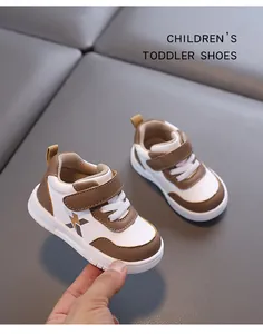 Close-up of brown and white leather toddler walking shoes with non-slip soft soles