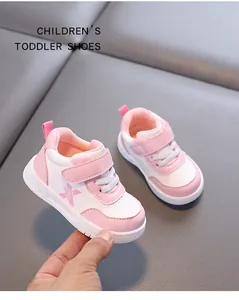 Detail shot of pink and white toddler walking shoes with waterproof leather and soft soles.