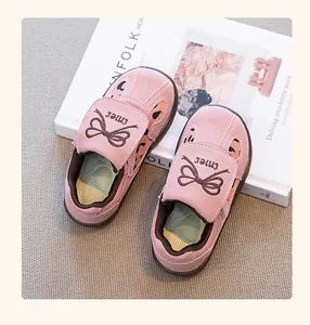Detalle de zapatillas casuales rosas para niña con bordado de lazo y material de ante