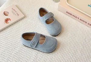 Detail view of retro light blue girls' Mary Jane shoes with soft sole and Velcro strap.