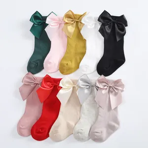 Colorful baby knee-high socks with large satin bows in ten different solid colors