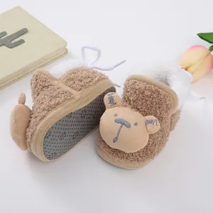 Detailed view of thick sherpa fleece baby booties with cute teddy bear face design