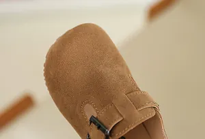 Detailed macro shot of brown suede texture on children's Birkenstock style clogs