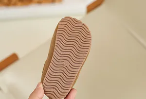 Detail of anti-slip wavy rubber sole on brown toddler Birkenstock style shoes