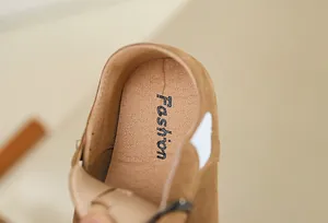Close-up detail of the textured leather insole in a brown children's casual loafer shoe