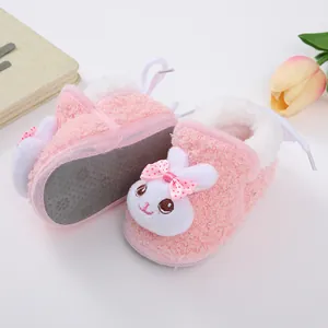 Close-up of pink plush baby walker shoes with cute rabbit face and bow detail