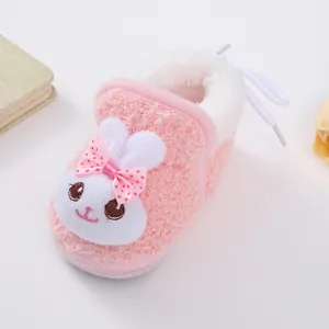 Close-up of pink baby winter fleece shoe with cute rabbit and bow detail