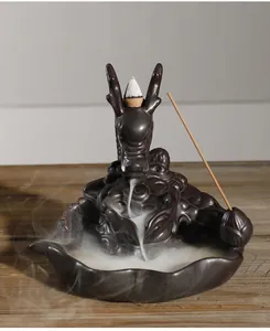 Detailed close-up of a ceramic dragon backflow incense burner with flowing smoke effect