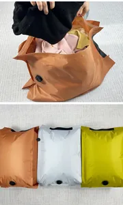 Airtight vacuum compression storage bags for clothes in orange, white and lime green