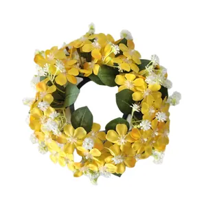 Artificial yellow and white floral wreath candle ring for home and wedding decor.