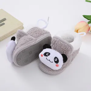 Close-up of fuzzy baby walking shoes featuring a cute plush panda face design.