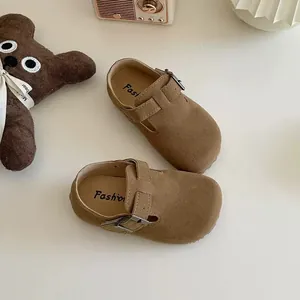Classic brown suede children's Birkenstock style shoes featuring adjustable metal buckle straps