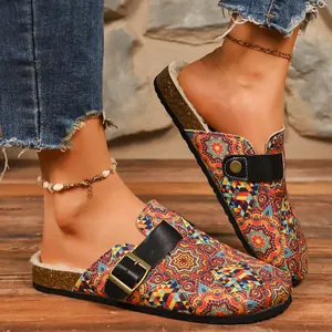 Close-up of ethnic style printed clogs with black buckle strap and cozy warm fur lining