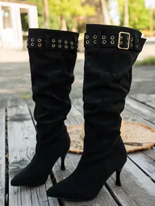 Elegant black suede knee-high boots with stiletto heels and buckle detail.