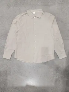 Full front view of men's loose linen casual long sleeve button down shirt in beige.