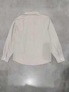 Back view of a casual loose fit men's beige linen long sleeve button-down shirt.