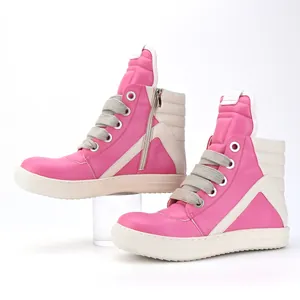 Chunky laces on high-top pink and cream men's designer style casual sneakers.