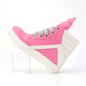 Side view of pink high-top platform sneaker with chunky laces and contrast panels