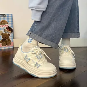 Stylish white autumn sneakers for girls featuring cute light blue butterfly decorations