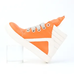 Side detail of vibrant orange men's high-top sneakers with chunky thick laces.
