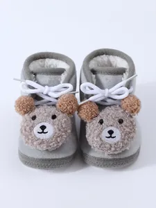 Detailed view of cute grey baby winter booties featuring a plush teddy bear face design