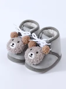 Detailed view of baby winter fleece-lined shoes with cute bear motif and white laces