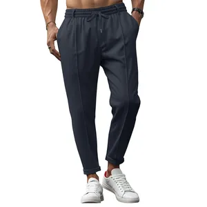 Premium men's dark blue drawstring tapered trousers featuring front crease and slim fit