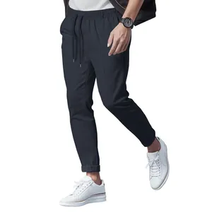 Slim fit men's casual drawstring pants with tapered leg in solid navy blue color