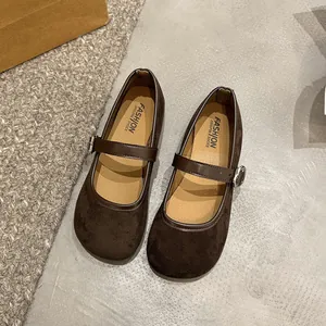 Detailed view of brown suede Mary Jane shoes with adjustable buckle strap and soft sole