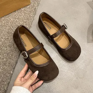 Close-up detail of dark brown suede Mary Jane flats featuring a cute silver heart buckle.