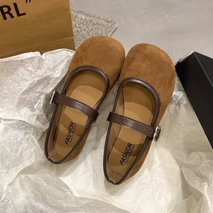 Detailed view of brown suede Mary Jane flats with buckle strap and round toe design