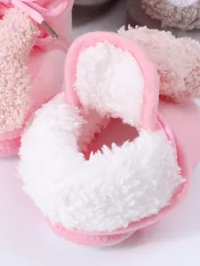 Close-up detail showing the soft white plush lining of pink baby winter booties