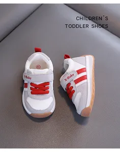 Macro view of breathable grey and red toddler shoes featuring soft non-slip rubber soles