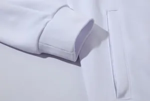 Gros plan d'un détail de veste de sport blanche montrant le poignet et la poche.