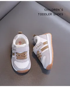 Close-up of breathable mesh toddler German trainer shoes in grey and white colors.