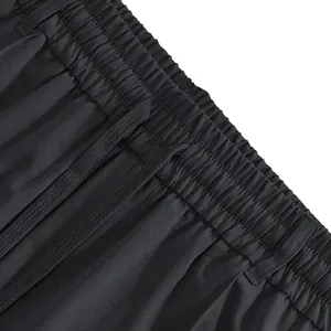Detailed macro shot of men's casual pants showing the elastic drawstring waistband design