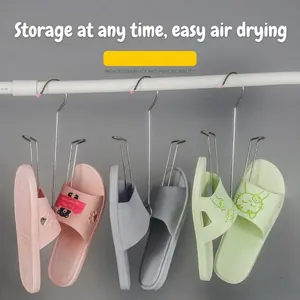 Detail view of stainless steel shoe drying hooks hanging slippers on a horizontal rod.