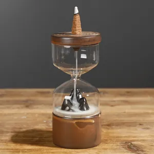 Creative backflow incense burner with hourglass glass cover and scenic mountain landscape