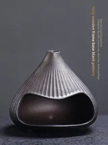 Macro view of a ceramic mountain-shaped incense burner featuring elegant ribbed texture