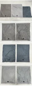 Multiple sizes and colors of hand-roll vacuum storage bags featuring vertical stripes