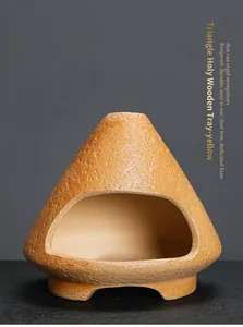 Close-up detail of a yellow triangle ceramic aromatherapy burner for Palo Santo and sage