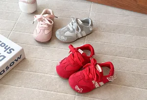 Group of girls' sneakers with delicate bow embroidery and lace detailing in three colors