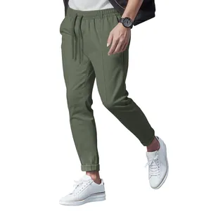 Full view of men's olive green casual drawstring joggers with a slim fit tapered cut