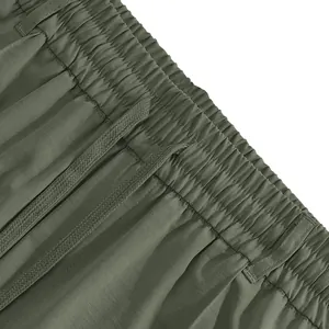 Close-up detail of elastic waistband with drawstring on men's olive green casual pants