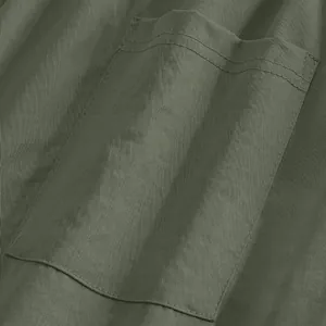 Detailed macro view of patch pocket stitching on men's olive green casual trousers