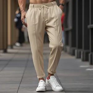 Detail of beige men's drawstring business casual trousers in a slim fit street style