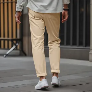 Detail of beige slim fit men's casual pants shown from behind in a street setting.