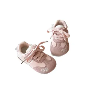 Stylish pink children's sneakers with bow embroidery and lace trim for young girls