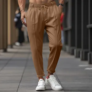 Men's slim-fit tapered trousers in camel brown with drawstring waist and leg pleats
